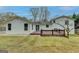 The exterior of the home features a wood deck overlooking a large backyard with mature trees at 5155 Rosestone Nw Dr, Lilburn, GA 30047