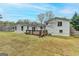 A spacious backyard features a wood deck and the exterior of the home with a neutral color scheme at 5155 Rosestone Nw Dr, Lilburn, GA 30047