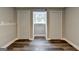 Finished basement area with wood-look floors, a window and two storage closets at 5155 Rosestone Nw Dr, Lilburn, GA 30047