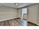 Finished basement with hardwood-look floors, a window, and two closet doors at 5155 Rosestone Nw Dr, Lilburn, GA 30047