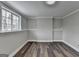 Finished basement space with dark wood-look floors, wainscoting and natural light from a window at 5155 Rosestone Nw Dr, Lilburn, GA 30047