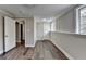 Finished basement space with wood-look floors, wainscoting, two doors and a window at 5155 Rosestone Nw Dr, Lilburn, GA 30047