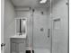 Modern bathroom with white marble shower, glass doors, gray vanity, and chrome fixtures at 5155 Rosestone Nw Dr, Lilburn, GA 30047