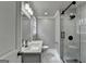 Bright bathroom with a quartz countertop, modern fixtures, and a glass-enclosed shower with marble tiling at 5155 Rosestone Nw Dr, Lilburn, GA 30047