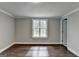 Bedroom featuring hardwood floors, neutral walls, a window and white trim at 5155 Rosestone Nw Dr, Lilburn, GA 30047