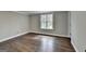 Bedroom featuring wood floors, neutral walls, and natural light from a window at 5155 Rosestone Nw Dr, Lilburn, GA 30047