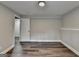 Bedroom featuring wood-look floors, neutral walls and two doors at 5155 Rosestone Nw Dr, Lilburn, GA 30047