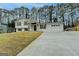 Spacious split-level home with a long concrete driveway leading to an attached two-car garage at 5155 Rosestone Nw Dr, Lilburn, GA 30047