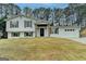 Charming split-level home featuring a fresh white exterior, rustic shutters, and attached two-car garage at 5155 Rosestone Nw Dr, Lilburn, GA 30047