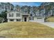 Charming split-level home featuring a fresh white exterior, rustic shutters, and attached two-car garage at 5155 Rosestone Nw Dr, Lilburn, GA 30047