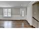Bright foyer featuring hardwood floors, a new window, white trim, and a closet near the stairs at 5155 Rosestone Nw Dr, Lilburn, GA 30047