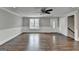 Bright foyer featuring hardwood floors, a new window, white trim, and a closet near the stairs at 5155 Rosestone Nw Dr, Lilburn, GA 30047