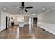 Open-concept kitchen features white cabinets, stainless appliances, hardwood floors, and ample natural light at 5155 Rosestone Nw Dr, Lilburn, GA 30047