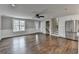 Bright living room features hardwood floors, a ceiling fan, and a large window providing ample natural light at 5155 Rosestone Nw Dr, Lilburn, GA 30047