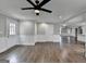 Spacious living room with hardwood floors, white trim, neutral paint, and doorways leading to other rooms at 5155 Rosestone Nw Dr, Lilburn, GA 30047