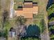 Backyard aerial view showcasing a fenced yard with mature trees and a charming patio at 105 Overlook Dr, Mcdonough, GA 30252