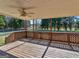 Large covered back porch features lattice railings, ceiling fan, and backyard views at 105 Overlook Dr, Mcdonough, GA 30252