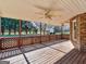 Large back porch features lattice railings, ceiling fan, and view into yard with utility shed at 105 Overlook Dr, Mcdonough, GA 30252