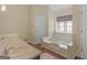 Well-lit bathroom featuring a soaking tub, double sinks, and wood-look flooring at 105 Overlook Dr, Mcdonough, GA 30252