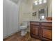 Bathroom with updated dark wood vanity, tile floors, shower with curtain and fixtures at 105 Overlook Dr, Mcdonough, GA 30252