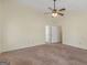 Large bedroom with neutral walls, carpet, ceiling fan, and access to two closets at 105 Overlook Dr, Mcdonough, GA 30252