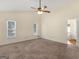 Sunny bedroom with carpeted floors, a vaulted ceiling, and plenty of natural light from two windows at 105 Overlook Dr, Mcdonough, GA 30252