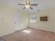 Standard bedroom with neutral carpet, ceiling fan, window, and mini fireplace on wall at 105 Overlook Dr, Mcdonough, GA 30252