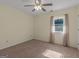 Bedroom features carpeted floors, ceiling fan, window with view and natural light at 105 Overlook Dr, Mcdonough, GA 30252