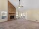 Spacious living room with a large brick fireplace, ceiling fan, and big windows at 105 Overlook Dr, Mcdonough, GA 30252