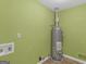 Functional utility room with water heater, washing machine connections, and green walls at 105 Overlook Dr, Mcdonough, GA 30252