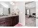 Bathroom showcasing a dark vanity with marble countertop and framed mirror with an adjoining home office at 1734 Tricklin Spgs, Mcdonough, GA 30252
