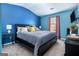 Bedroom featuring blue walls, soft carpet, vaulted ceiling, and a window to allow natural light at 1734 Tricklin Spgs, Mcdonough, GA 30252