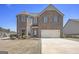 Two story brick home with attached two car garage and well manicured landscaping in a suburban neighborhood at 1734 Tricklin Spgs, Mcdonough, GA 30252