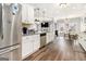 Bright, open kitchen with stainless steel appliances and an eat-in bar, flowing into the living and dining areas at 1734 Tricklin Spgs, Mcdonough, GA 30252