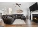 Spacious living room with hardwood floors, a fireplace, and a large sectional sofa perfect for entertaining at 1734 Tricklin Spgs, Mcdonough, GA 30252