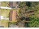 Aerial view of a home with a brown roof, surrounded by green grass and trees at 447 Wavelyn Way, Riverdale, GA 30274