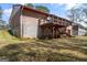 A spacious backyard reveals a raised wooden deck and a covered patio with a staircase at 447 Wavelyn Way, Riverdale, GA 30274