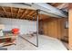 Unfinished basement with exposed ceiling, concrete floors, and minimal furnishings at 447 Wavelyn Way, Riverdale, GA 30274