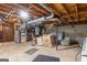 Spacious unfinished basement with exposed beams and ductwork, and minimal furnishings at 447 Wavelyn Way, Riverdale, GA 30274