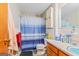 A clean bathroom features tiled walls, blue accents, a cabinet, and a toilet at 447 Wavelyn Way, Riverdale, GA 30274