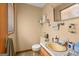 Modest bathroom featuring a yellow sink, toilet, and a mirrored medicine cabinet at 447 Wavelyn Way, Riverdale, GA 30274