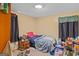 Simple bedroom featuring a bed, small wooden nightstand, and basic furnishings at 447 Wavelyn Way, Riverdale, GA 30274