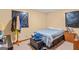 This bedroom is simple, with carpeted floors, a bed, and a wooden dresser at 447 Wavelyn Way, Riverdale, GA 30274