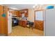 Cozy kitchen with wood cabinets, black appliances, linoleum floors, and a charming backdoor at 447 Wavelyn Way, Riverdale, GA 30274