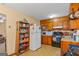 The kitchen features wood cabinets, linoleum floors, white appliances, and ample storage space at 447 Wavelyn Way, Riverdale, GA 30274