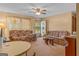 The living room offers a ceiling fan, carpeted floors, and two sofas, creating a cozy atmosphere at 447 Wavelyn Way, Riverdale, GA 30274