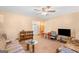 The living room features carpeted floors and is furnished with comfortable seating and a TV at 447 Wavelyn Way, Riverdale, GA 30274