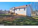 Large backyard with grass and a two story home with a wooden deck at 89 Farm Brook Ln # 17, Dallas, GA 30157