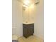 Bathroom features a vanity with mirror, toilet, and patterned linoleum floor at 89 Farm Brook Ln # 17, Dallas, GA 30157