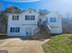 Split-level home with two-story entryway, vinyl siding, shutters, and a concrete driveway at 89 Farm Brook Ln # 17, Dallas, GA 30157